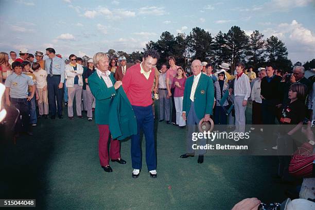 After the "tap in" for his par, George Archer is congratulated by Tom Weiskopf on the 18th round in final round of the 1969 Masters Golf Tournament...