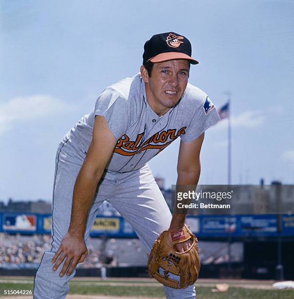 Brooks Robinson, infielder for the Baltimore Orioles is shown crouching down with his hands on his knees in a playing position.