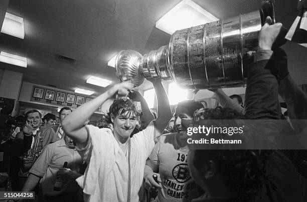 Bruins' Bobby Orr enjoys a champagne shower from the Stanley Cup during jubilation in dressing room after the Bruins captured the coveted cup in a...