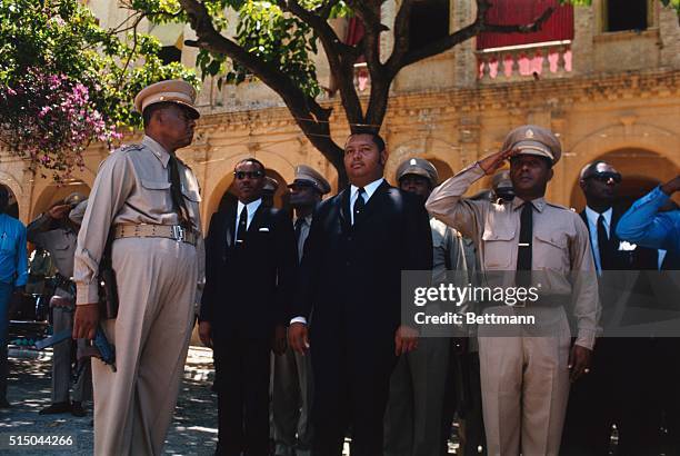 Port-au-Prince, Haiti: President Jean Claude Duvalier, named chief executive after death of his father "Papa Doc," reviews Army troops here. He is...