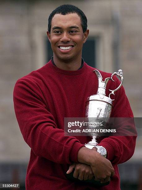 Tiger Woods of the US holds the winner's claret jug trophy after his victory at the British Open Championship 23 July 2000. Woods scored a 269,...