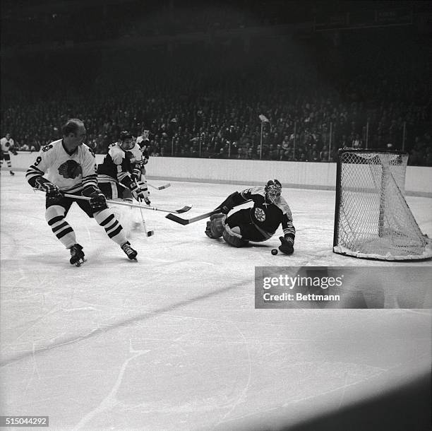 Boston goalie Gerry Cheevers makes a glove save on shot by Black Hawks' Bobby Hull in the second period at Chicago Stadium 3/24. Bruins' defenseman...