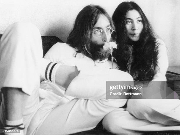 Musician John Lennon and wife Yoko Ono at a press conference from their bed in 1969. The couple announced that they would stay in bed seven days "to...