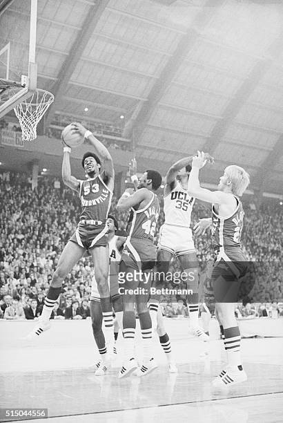 Artis Gilmore of the Jacksonville University Dolphins Basketball Team grabs the rebound during the finals of an NCAA tournament against UCLA. UCLA...