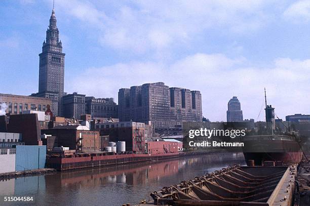 Views of the Cuyahoga River shown here, the river is a constant fire hazard because of quantities of oil deposited in it by numerous industries in...