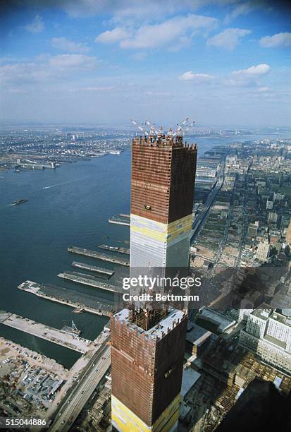 New York: Airview of one of the two towers of the World Trade Center, as workers put into place steel sections which brought the building to a height...