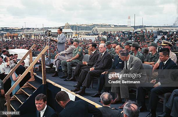 President Johnson, South Vietnam's unexpected visitor, addresses the troops stationed here. With Johnson on the speaker's platform are : Gen. William...