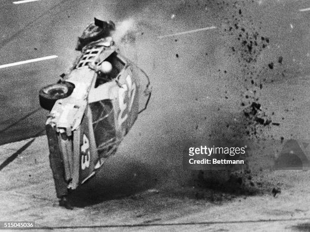 Richard Petty's arm hangs out the window of his Plymouth after the veteran stock car driver hit the retaining wall along the pits and took off on...