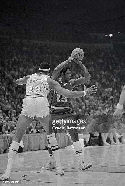 Inglewood, California: Los Angeles Lakers Wilt Chamberlain tries to block a throw by New York Knicks Willis Reed as Reed looks over for a possible...
