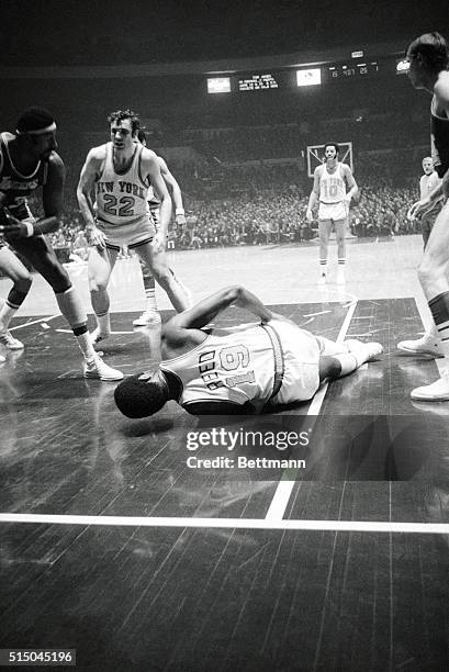 Knick's Willis Reed limps off the court here after his injury, accompanied by trainer Danny Whalen, in the NBA Playoff Series, and 5th game between...