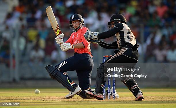 Joe Root of England hits past New Zealand wicketkeeper Luke Ronchi during the ICC Twenty20 World Cup warm up match between New Zealand and England at...