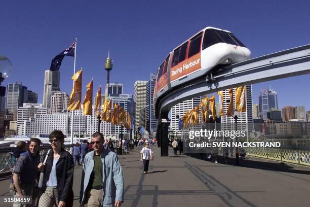 Tourists enjoy a walk around Sydney's Darling Harbour 10 September 2000, five days before the opening of the 2000 Summer Olympics.