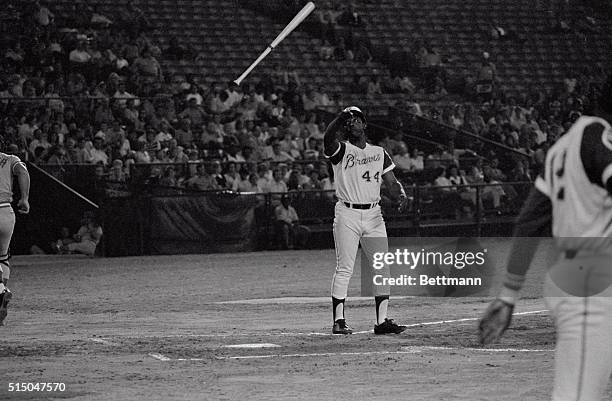 Atlanta's Hank Aaron, only seven hours away from breaking Babe Ruth's career home run record of 714, disgustingly throws his bat into the air, after...