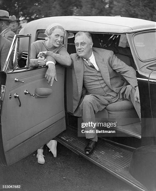 His daughter, Mrs. John Boettiger, beside him, President Roosevelt watches a baseball game between White House newspapermen and the Lowell Thomas...