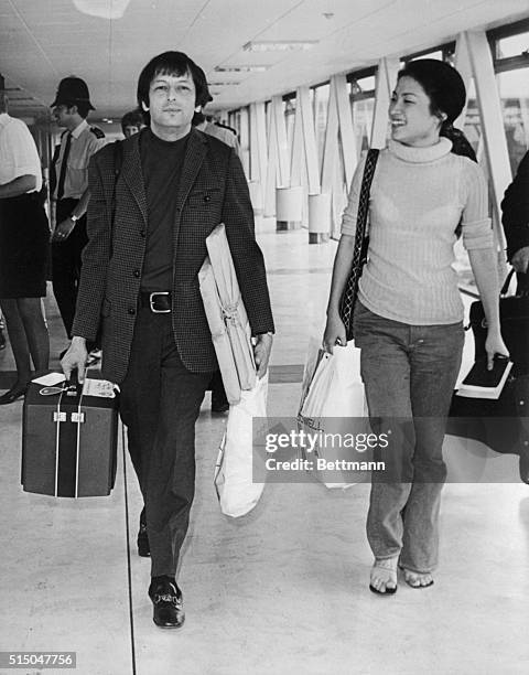 Composer-conductor Andre Previn arrives at the airport here May 12th with violinist Kyung Wha-Chung, from Hong Kong, following their tour of Russia...