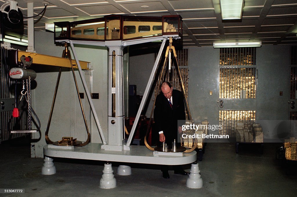 Man Weighing Gold Bars on a Scale