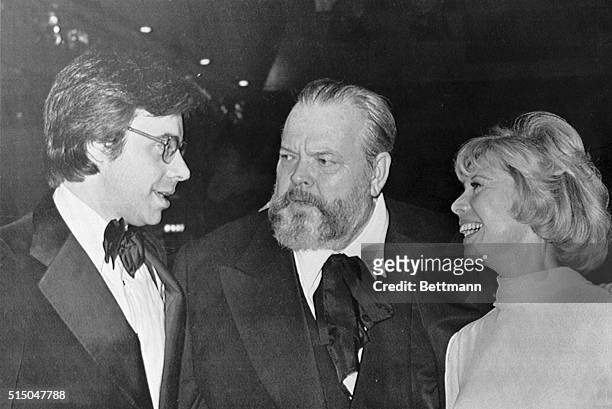 Director Peter Bogdanovich, and Dinah Shore chat with Orson Welles during the American Film Institute's presentation of the coveted Life Achievement...