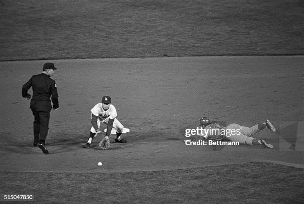 Pete Rose of Cincinnati slides safely into 2nd on a steal from 1st, as Dodgers 2nd baseman Bill Grabarkewitz bobbles the ball and dropped it to the...