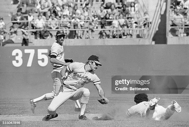 Oakland, Calif.: Oakland Athletics' Reggie Jackson goes head first into 2nd on this steal attempt in the third inning but was tagged out by Baltimore...