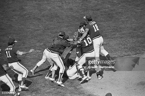 Oakland Athletics pitcher Jim "Catfish" Hunter tumbles to ground as he is mobbed by teamates after his 3-0 victory over the Baltimore Orioles at...