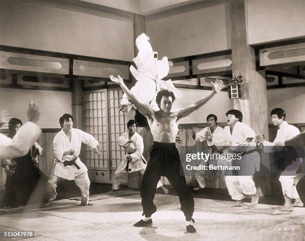 Picture shows actor, Bruce Lee, demonstrating a Kung-fu flip in the air of a Japanese boxing club member from a scene in "The Chinese Connection"....