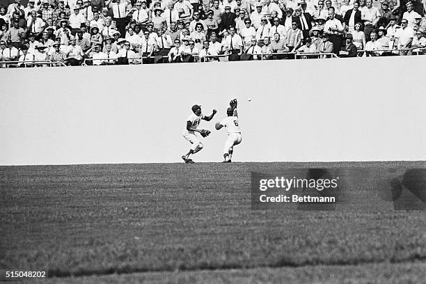 Dodgers' Willie Davis and Ron Fairly both miss catching a ball hit to right-center by Baltimore Orioles' Frank Robinson in the sixth inning of the...