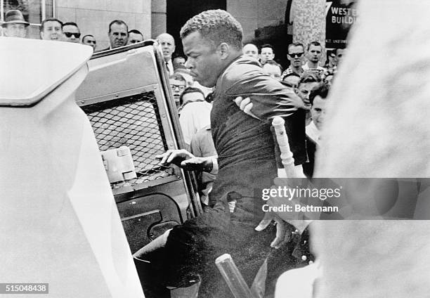 John Lewis national chairman of the Student Non-violent Coordinating Committee , is ushered into police patrol wagon during racial demonstration here...