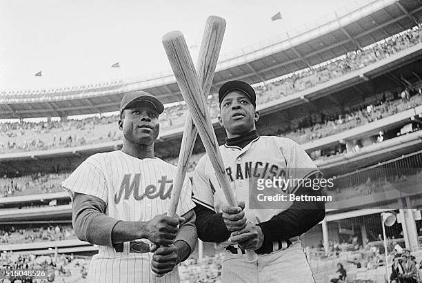 The fabulous Willie Mays, , centerfielder of the San Francisco Giants, crosses his "hot bat" with the bat of rightfielder Joe Christopher of the New...