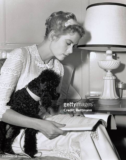 Grace Kelly and her French poodle, "Oliver."