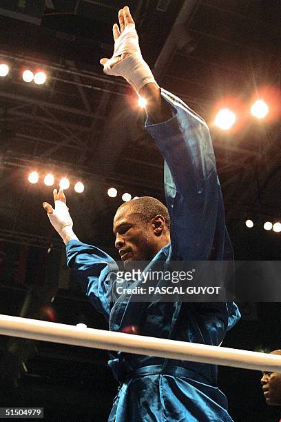Two-time Olympic Gold Medallist Felix Savon of Cuba acknowledges victory after stopping Nigeria's Rasmus Ojemaye in their preliminary second-round...