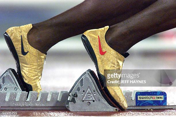Picture taken 25 September 2000 at the Olympic stadium of the specially-designed golden shoes of US track start Michael Johnson at the start of the...