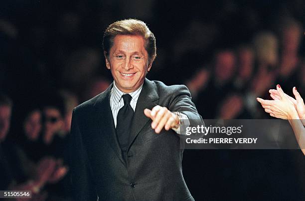 Valentino acknowledges the audience after his show 10 October 2000 in Paris during the Spring/Summer 2001 ready-to-wear collections.