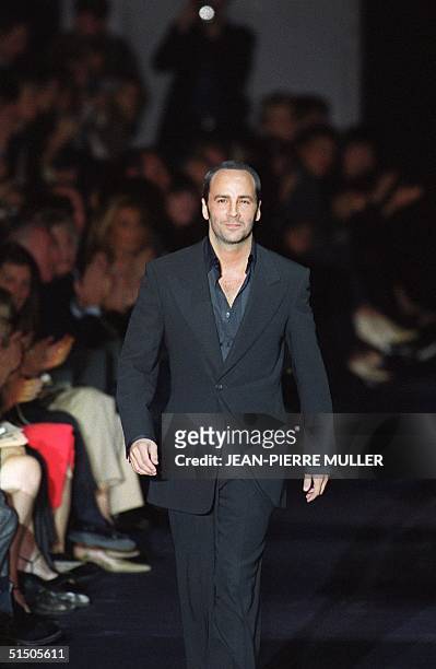 Designer Tom Ford acknowledges the audience after presenting his first ready-to-wear show for Yves Saint Laurent 13 October 2000 in Paris at the...