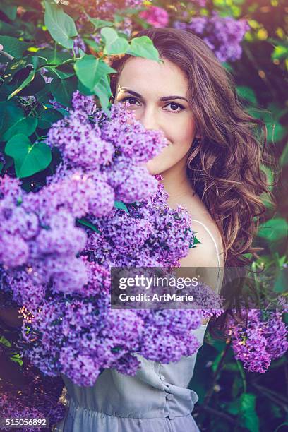 beautiful woman in park - lilac bush stock pictures, royalty-free photos & images