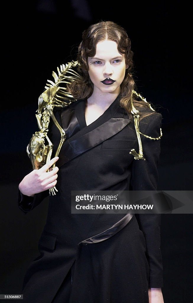 Alexander McQueen's model wears a gold-painted fox