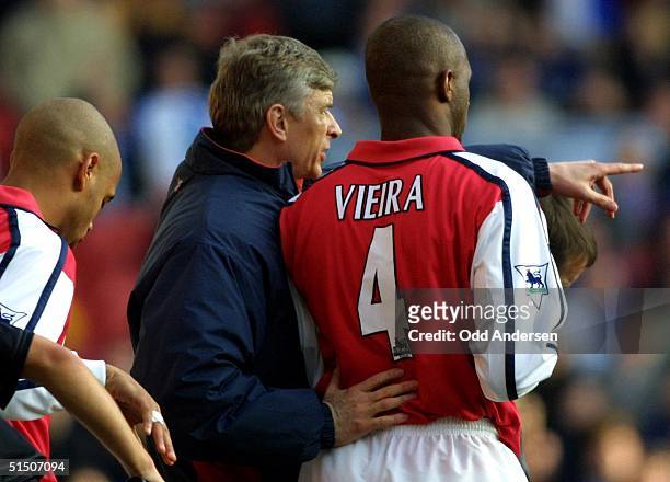 Arsenal`s French coach Arsene Wenger prepares substitutes Patrick Vieira and Thierry Henry during a FA cup quarterfinal match against Blackburn at...