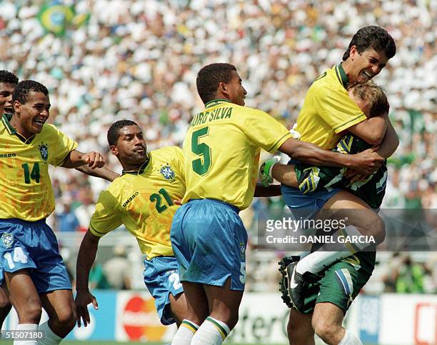 Brazilian forward Bebeto jumps to hug goalkeeper Claudio Taffarel, as teammates Cafu, Viola and Mauro Silva move in, after Italian Roberto Baggio...
