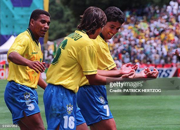 Brazilian forward Bebeto , imitated by Leonardo, celebrates his goal against Cameroon as Mauro Silva looks on during their World Cup first round...