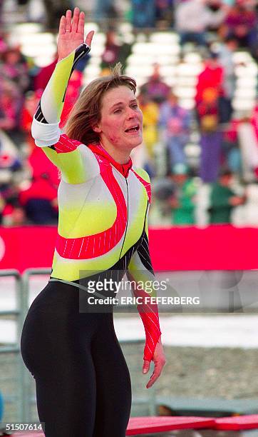 West German speed skater Gunda Niemann waves to the crowd as she catches her breath following her victory in the women's 5000m at the Winter Olympic...
