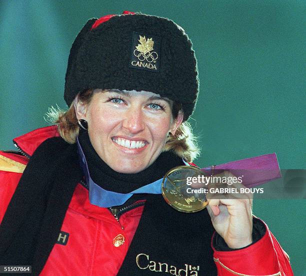 Canadian Myriam Bedard smiles as she displays her gold medal won in the women's 15km individual biathlon at the Winter Olympic Games 18 February 1994...