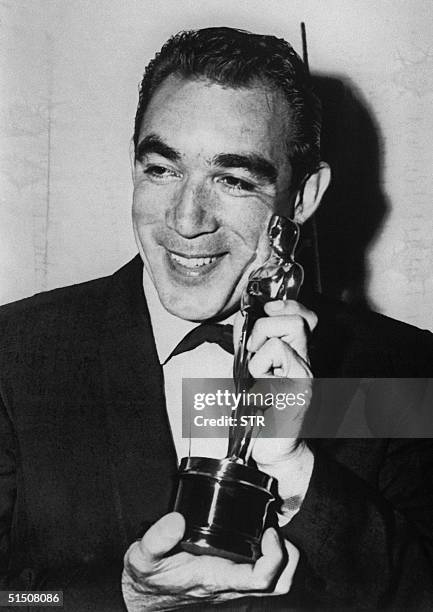 File photo dated 27 March 1957 shows US actor Anthony Quinn showing his Oscar for best actor in a supporting role in "Lust for Life" during the 29th...