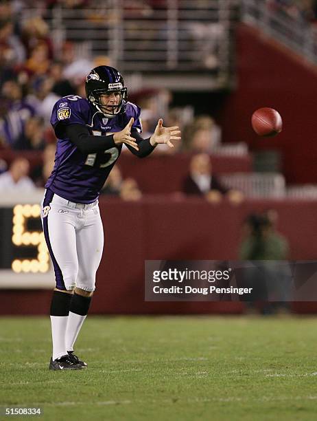 Punter Dave Zastudil of the Baltimore Ravens catches the ball against the Washington Redskins during the game at FedEx Field on October 10, 2004 in...