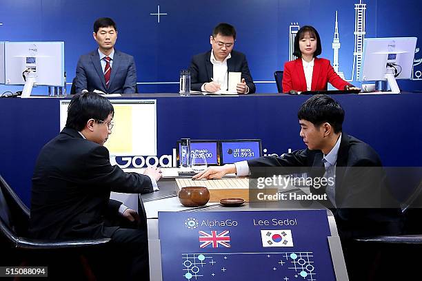 In this handout image provided by Google, South Korean professional Go player Lee Se-Dol puts his first stone against Google's artificial...