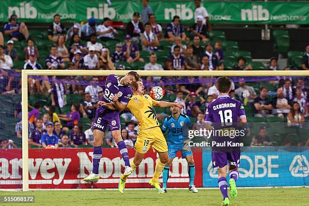 Dino Djulbic of the Glory and Josh Bingham of the Mariners contest a header during the round 23 A-League match between the Perth Glory and the...