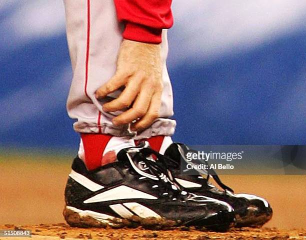 Pitcher Curt Schilling of the Boston Red Sox grabs at his ankle as it appears to be bleeding in the fourth inning during game six of the American...