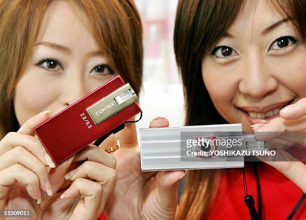 Models display world's smallest 4 mega-pixel digital camera "Contax i4R", produced by Japan's electronics giant Kyocera, at Asia's largest PC trade...