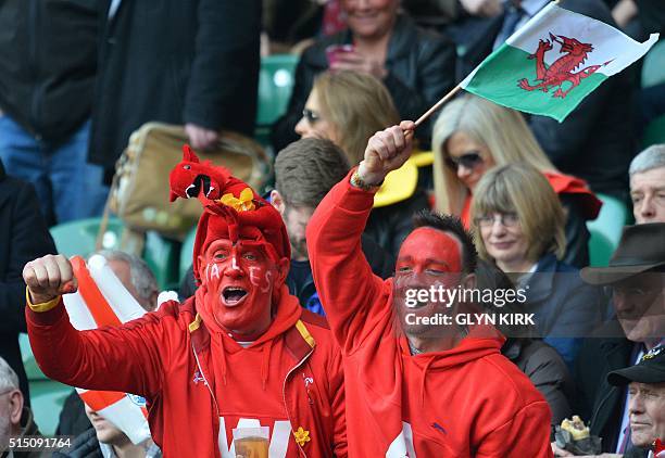 Welsh supporters with painted faces waves a flag ahead of the Six Nations international rugby union match between England and Wales at Twickenham in...