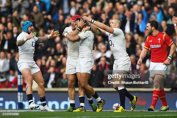 Anthony Watson of England celebrates scoring his team's opening try with James Haskell during the RBS Six Nations match between England and Wales at...