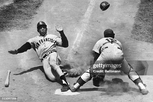 New York, NY- Slugger, Willie Mays, of the San Francisco Giants, slides into home plate safely after he tripled and came in when outfielder, Roy...