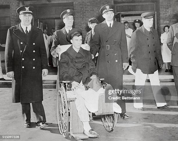 Coast Guardsman Clifford Johnson, of Sumner, Mo., last of the 166 hospitalized survivors of the Cocoa nut Grove disaster, as he was released from the...